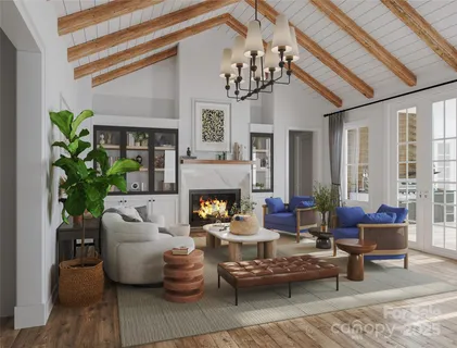 a living room with furniture a chandelier and a fireplace
