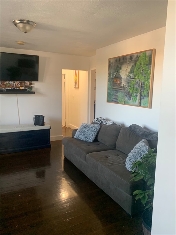 500 Beach Revere Revere Ma, Unit 1 Revere, MA 02151 - Photo 2 of 8 a living room with furniture and a flat screen tv
