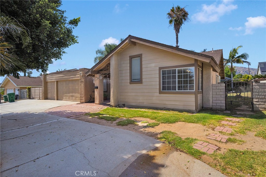 1087 Baseline Road La Verne, CA 91750 - Photo 4 of 39 a front view of a house with a yard and garage