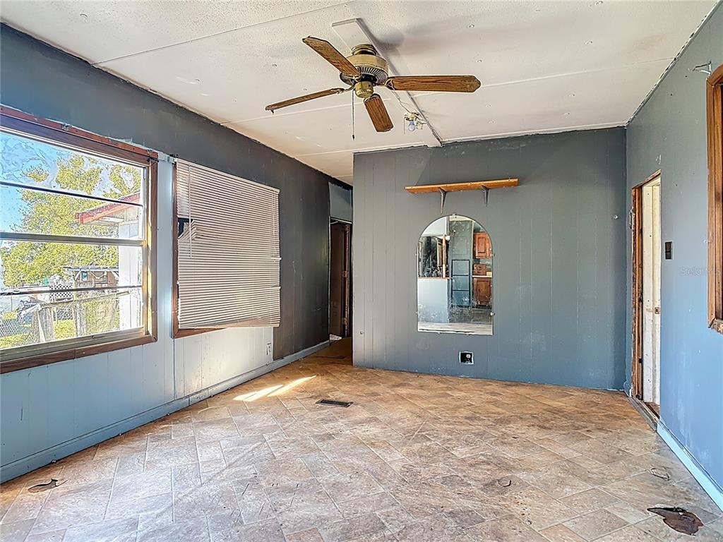 13005 Florida Avenue Astatula, FL 34705 - Photo 12 of 48 a view of a livingroom with a ceiling fan and window