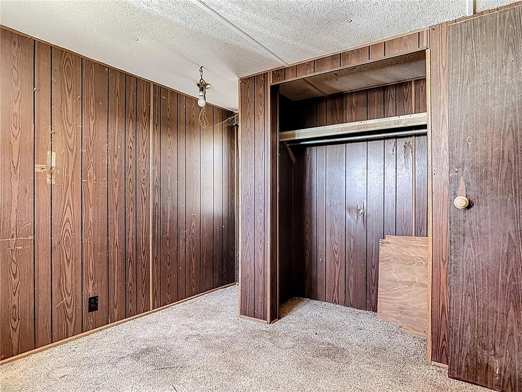 13005 Florida Avenue Astatula, FL 34705 - Photo 25 of 48 a view of an empty room with wooden walls