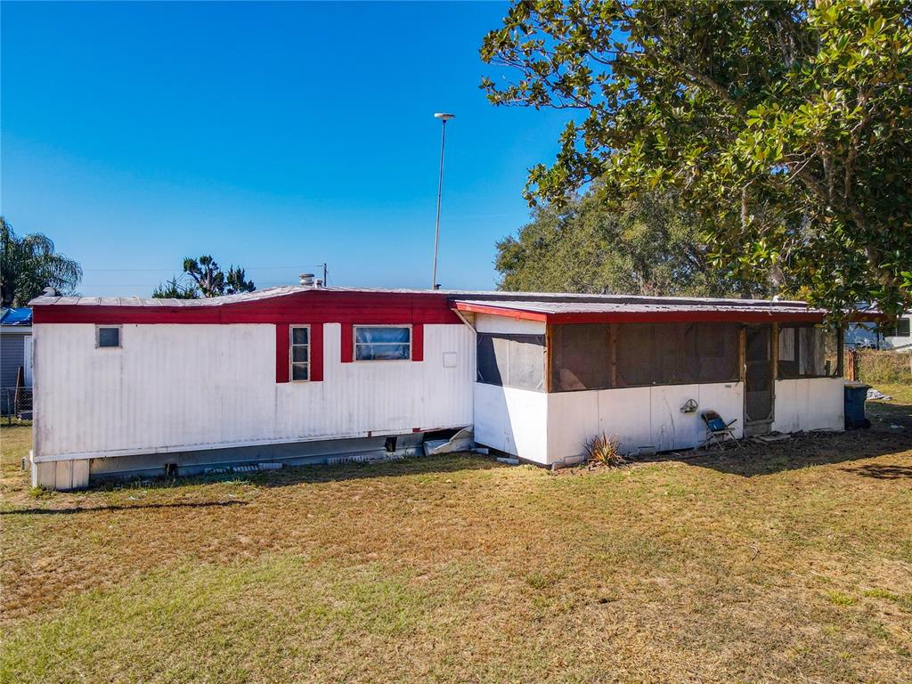 13005 Florida Avenue Astatula, FL 34705 - Photo 3 of 48 a front view of a house with a yard