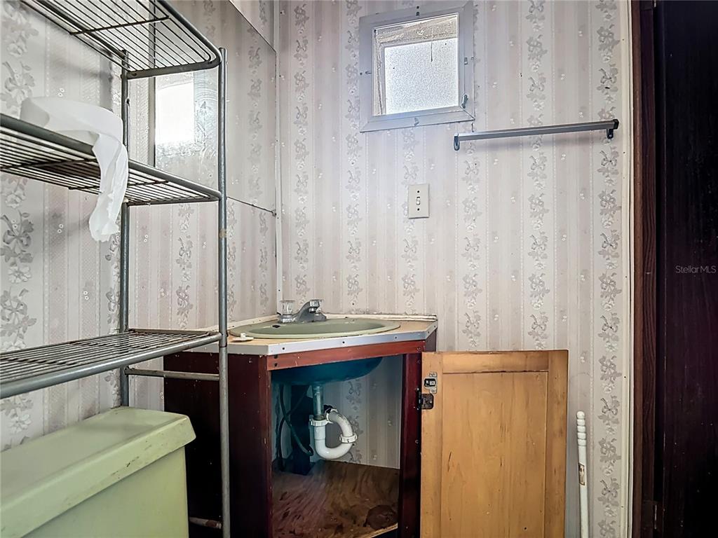 13005 Florida Avenue Astatula, FL 34705 - Photo 31 of 48 a bathroom with a sink and a mirror
