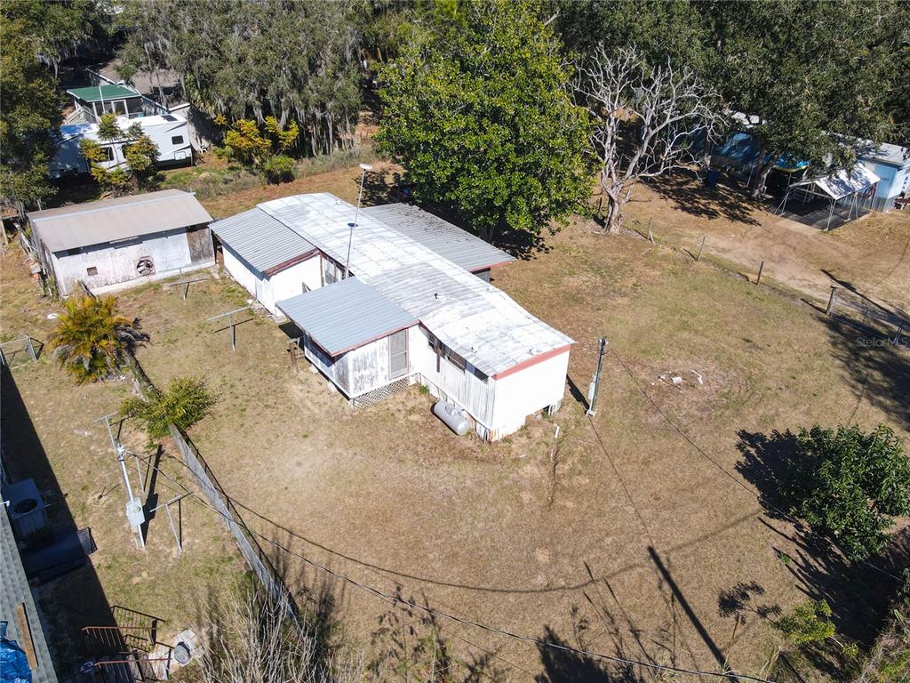 13005 Florida Avenue Astatula, FL 34705 - Photo 42 of 48 an aerial view of a house with a yard and trees