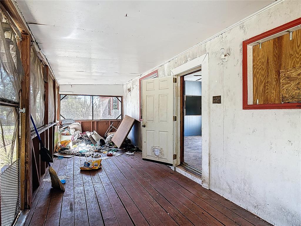 13005 Florida Avenue Astatula, FL 34705 - Photo 5 of 48 a view of a room with wooden floor furniture and windows
