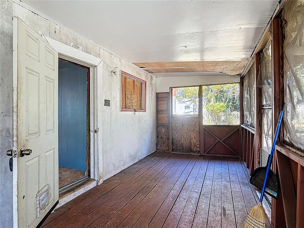 13005 Florida Avenue Astatula, FL 34705 - Photo 7 of 48 a view of an entryway with wooden floor and door