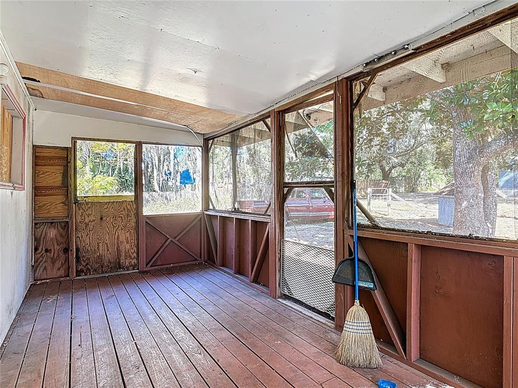 13005 Florida Avenue Astatula, FL 34705 - Photo 8 of 48 a view of a room with wooden floor and furniture