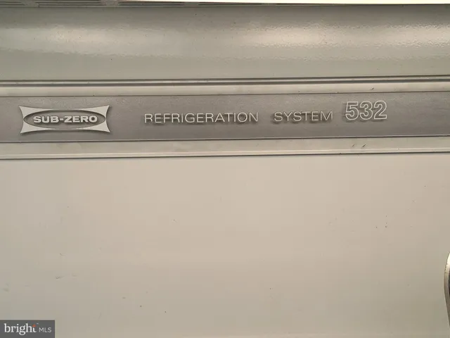 a close view of a stove in a white kitchen