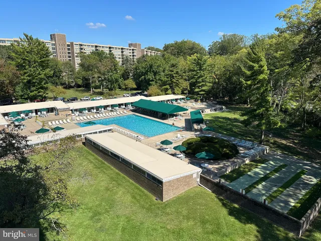 a view of a swimming pool with a yard