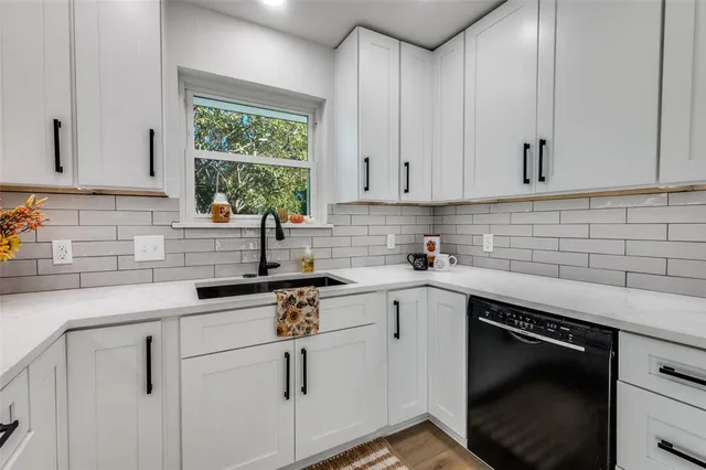 a kitchen with white cabinets and white appliances