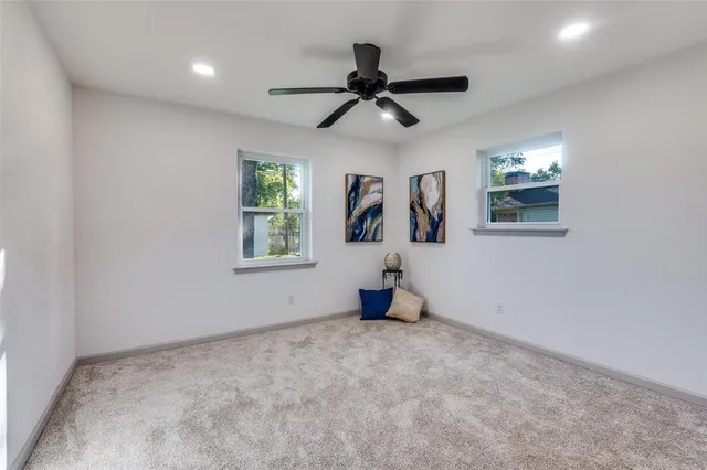 a view of a livingroom with a ceiling fan and window