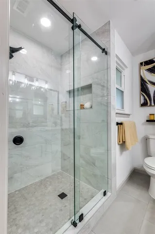 a bathroom with a shower and toilet