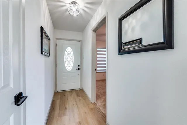 a view of a hallway with wooden floor