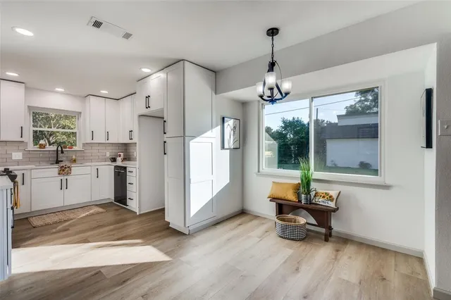 a living room with stainless steel appliances kitchen island granite countertop furniture and a wooden floor