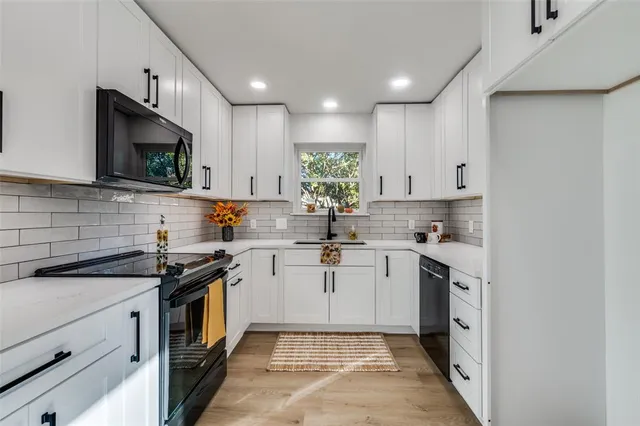a kitchen with a sink stove and cabinets