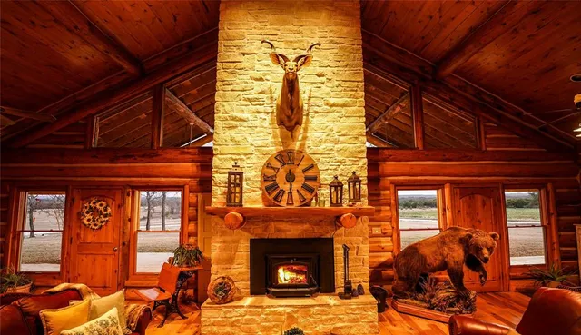 a living room with furniture a fireplace and a window