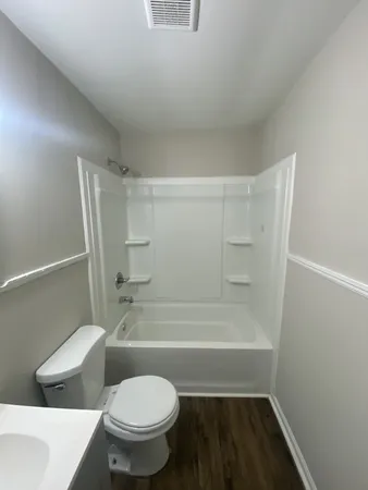 a bathroom with a toilet and a shower