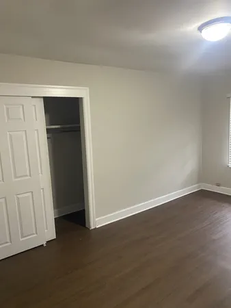an empty room with wooden floor