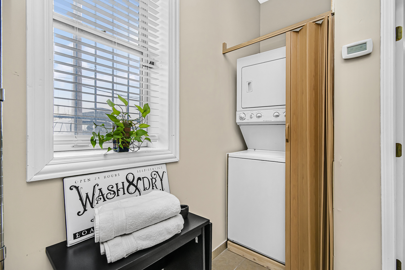 4346 North Pulaski Road, Unit C Chicago, IL 60641 - Photo 19 of 21 a hallway with a couch and a potted plant next to a window