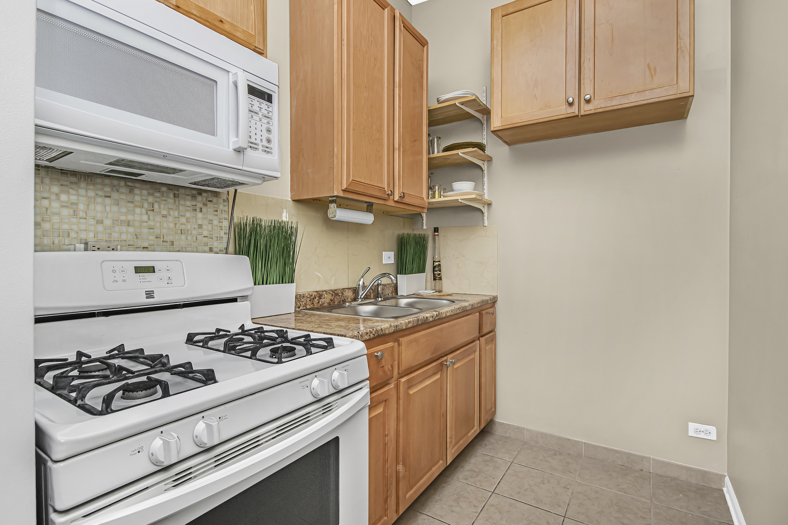 4346 North Pulaski Road, Unit C Chicago, IL 60641 - Photo 10 of 21 a kitchen with stainless steel appliances a stove and a microwave