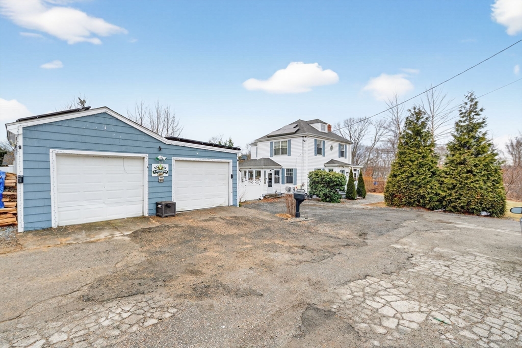 a view of a house with a yard and garage