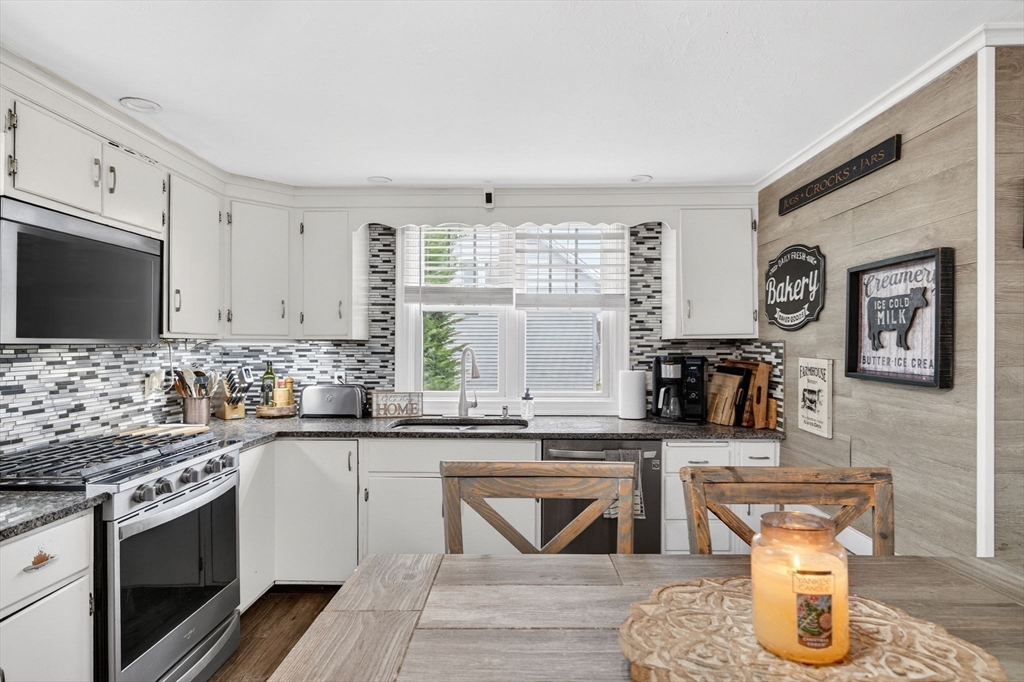 59 Glendale Street Fall River, MA 02720 - Photo 12 of 37 a kitchen with stainless steel appliances granite countertop a stove and a sink
