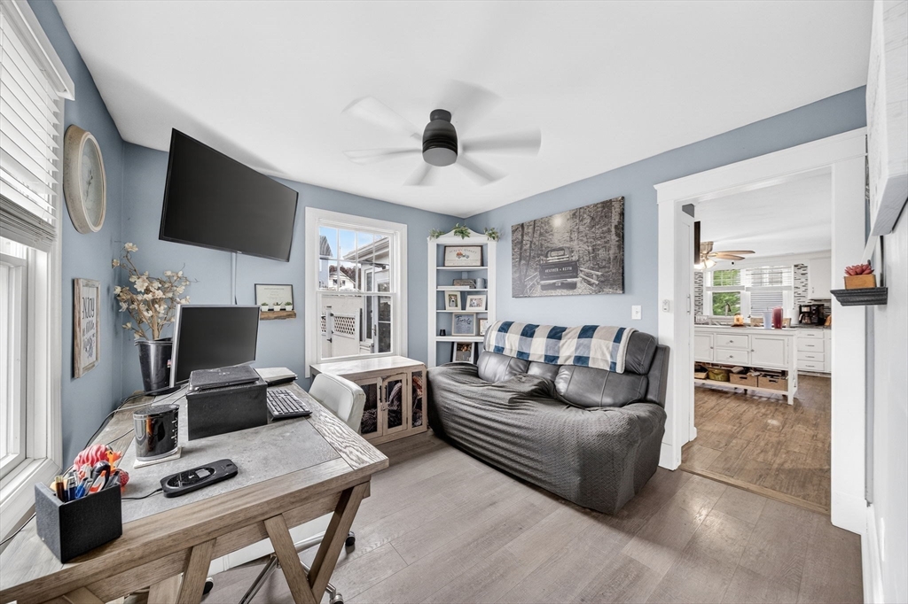 59 Glendale Street Fall River, MA 02720 - Photo 16 of 37 a living room with furniture a flat screen tv and a fireplace