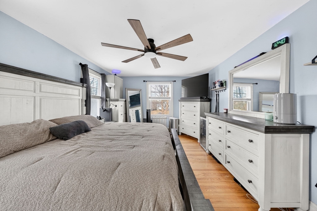 59 Glendale Street Fall River, MA 02720 - Photo 24 of 37 a large bedroom with a large bed and a chandelier