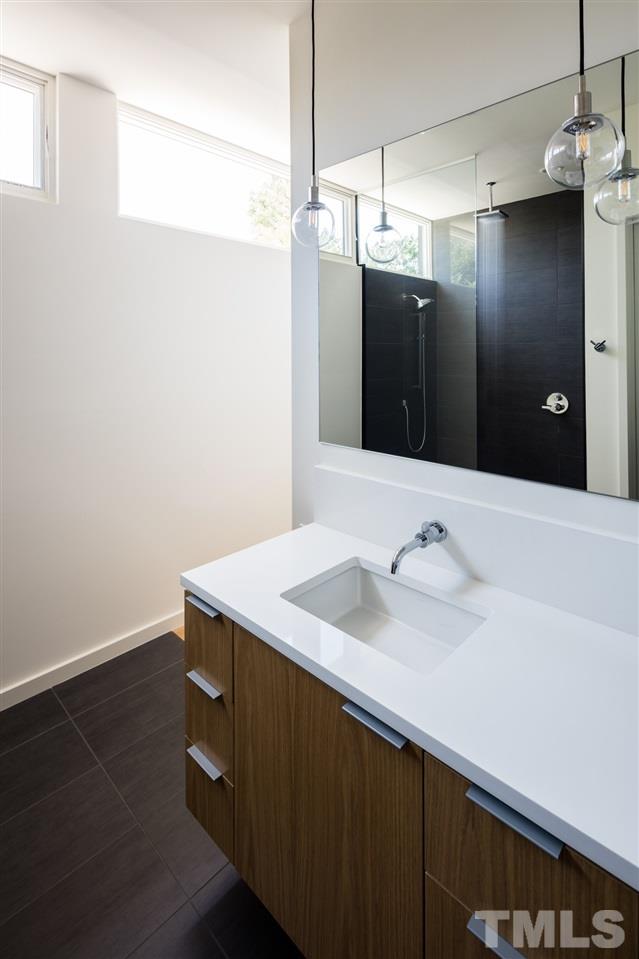 305 Horne Street Raleigh, NC 27607 - Photo 9 of 18 a bathroom with a sink and a mirror