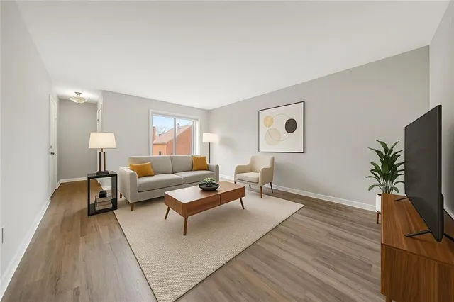 a living room with furniture and a flat screen tv with potted plants