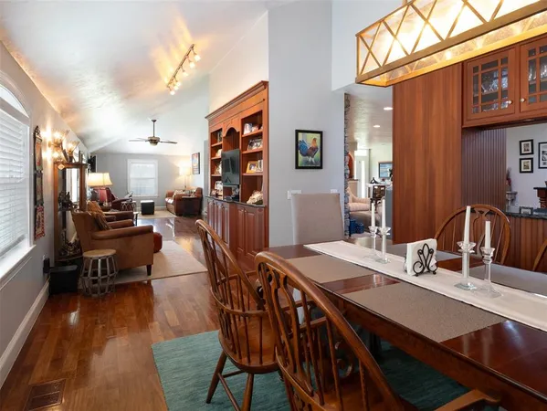 a view of a dining room with furniture and a chandelier