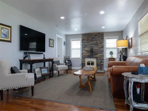 a living room with fireplace furniture and a flat screen tv