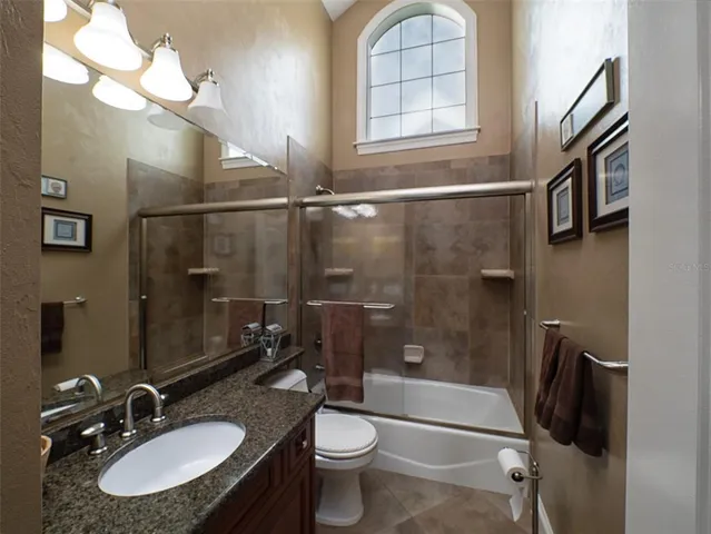 a bathroom with a sink toilet tub and shower