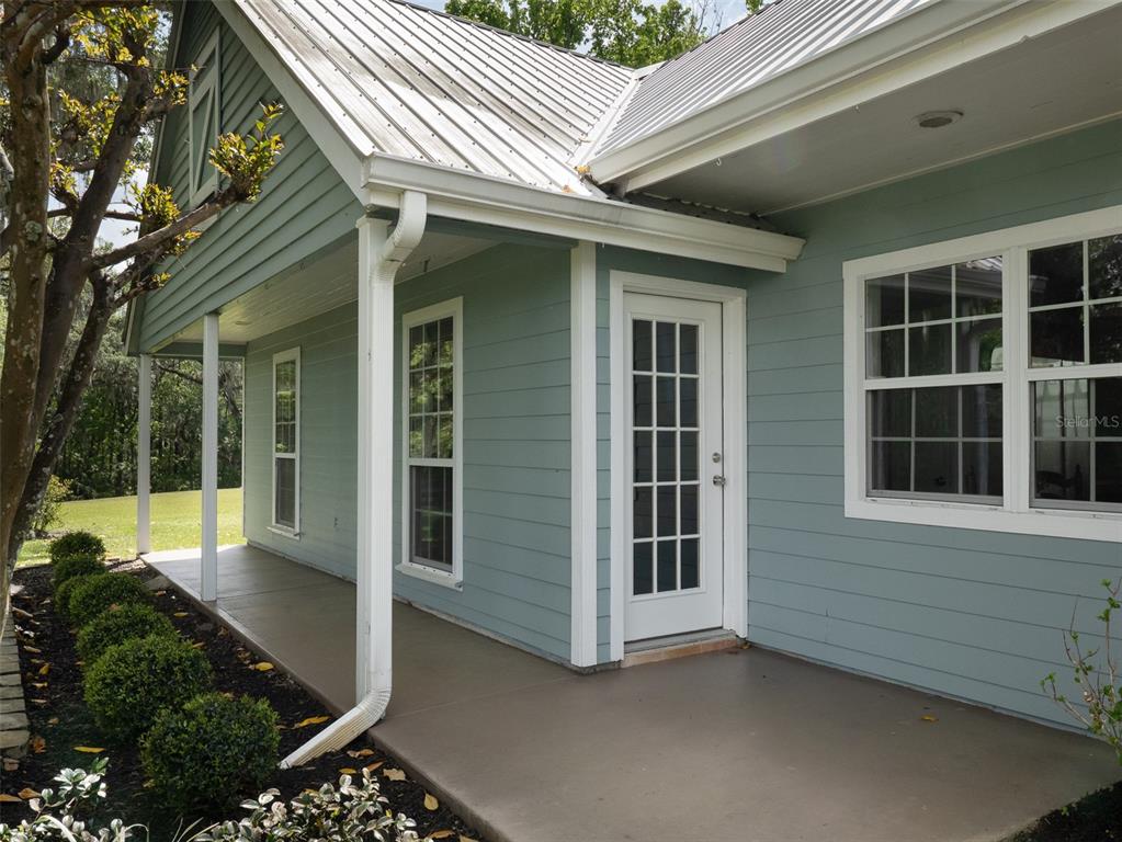 8393 Northwest 110th Street Reddick, FL 32686 - Photo 22 of 38 a view of a house with backyard and sitting area