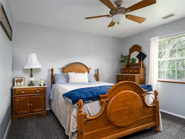 a bedroom with a bed and window