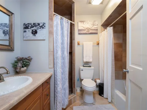 a bathroom with a toilet sink and shower