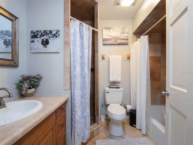 a bathroom with a toilet sink and shower