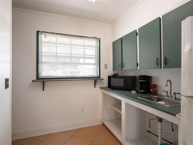 a kitchen with stainless steel appliances a sink a stove and a microwave