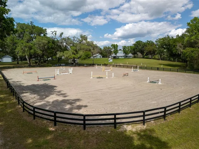 a view of a swimming pool with a yard and a lake view