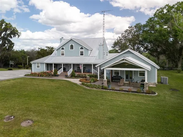 a front view of a house with a yard table and chairs