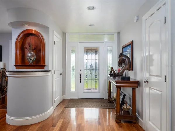 a view of a livingroom with wooden floor and a window