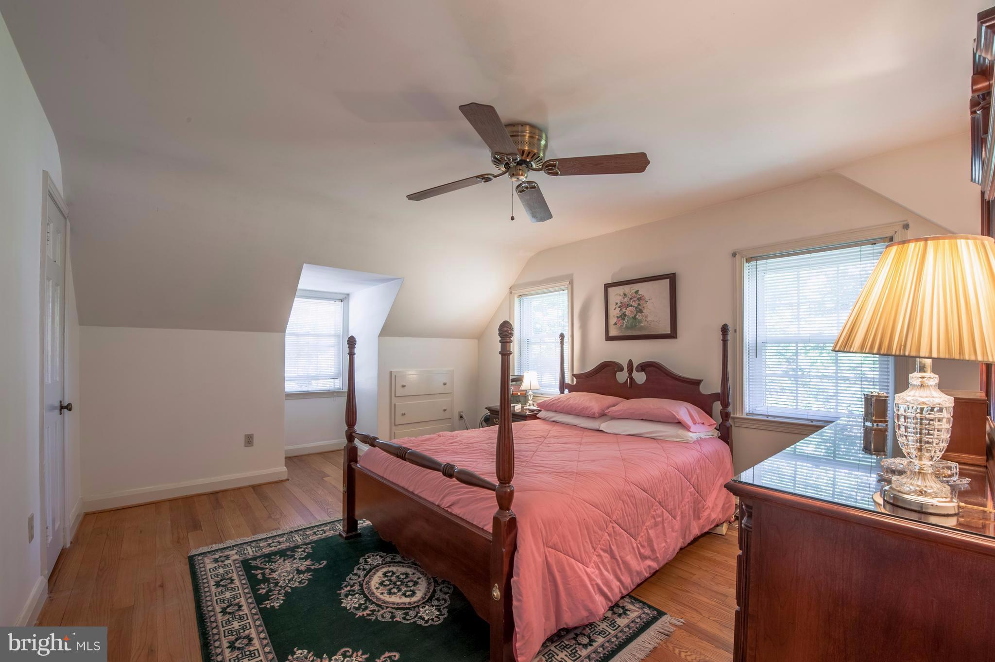 6507 Sharon Road Baltimore, MD 21239 - Photo 11 of 19 a bedroom with a bed and a lamp