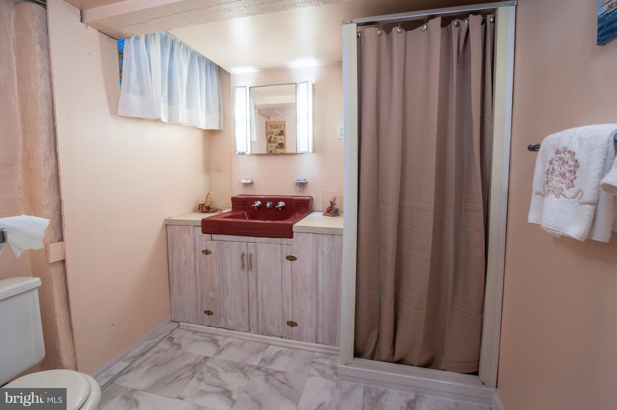 6507 Sharon Road Baltimore, MD 21239 - Photo 17 of 19 a bathroom with a sink toilet and shower