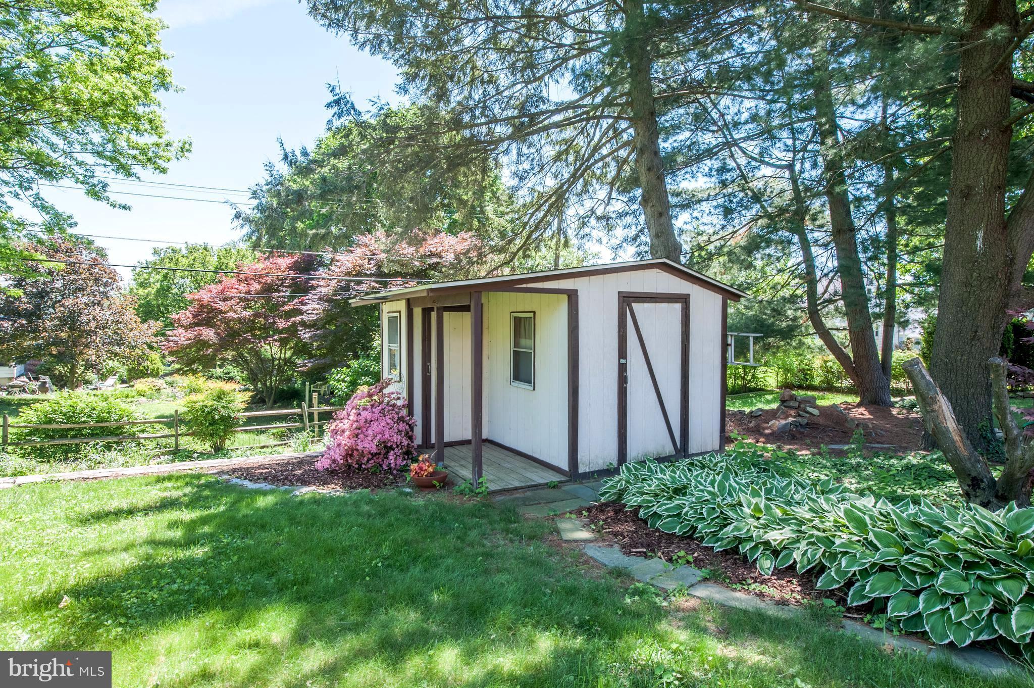 6507 Sharon Road Baltimore, MD 21239 - Photo 5 of 19 a view of backyard with large trees and potted plants