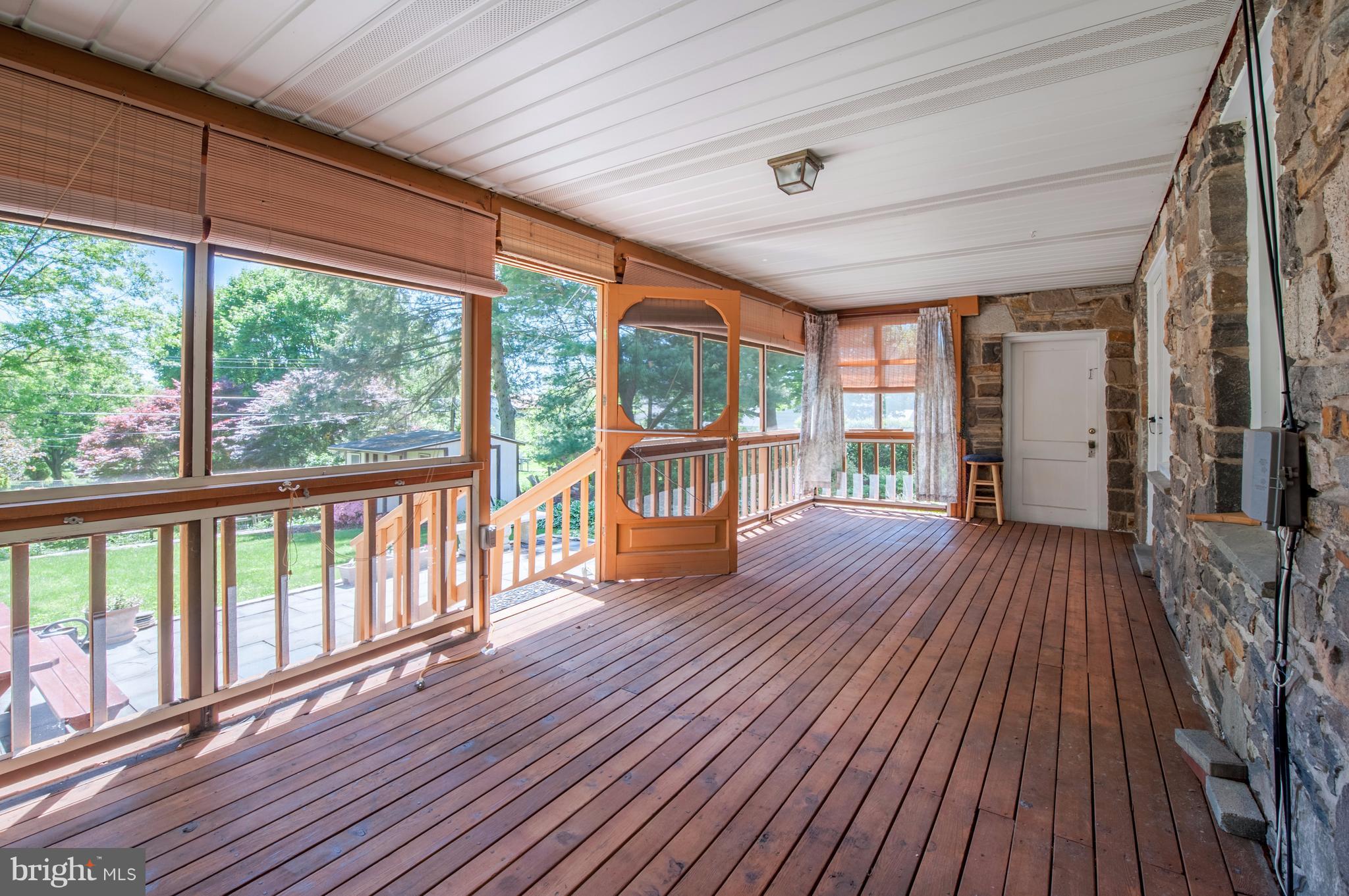 6507 Sharon Road Baltimore, MD 21239 - Photo 10 of 19 a view of a porch with wooden floor and outdoor space