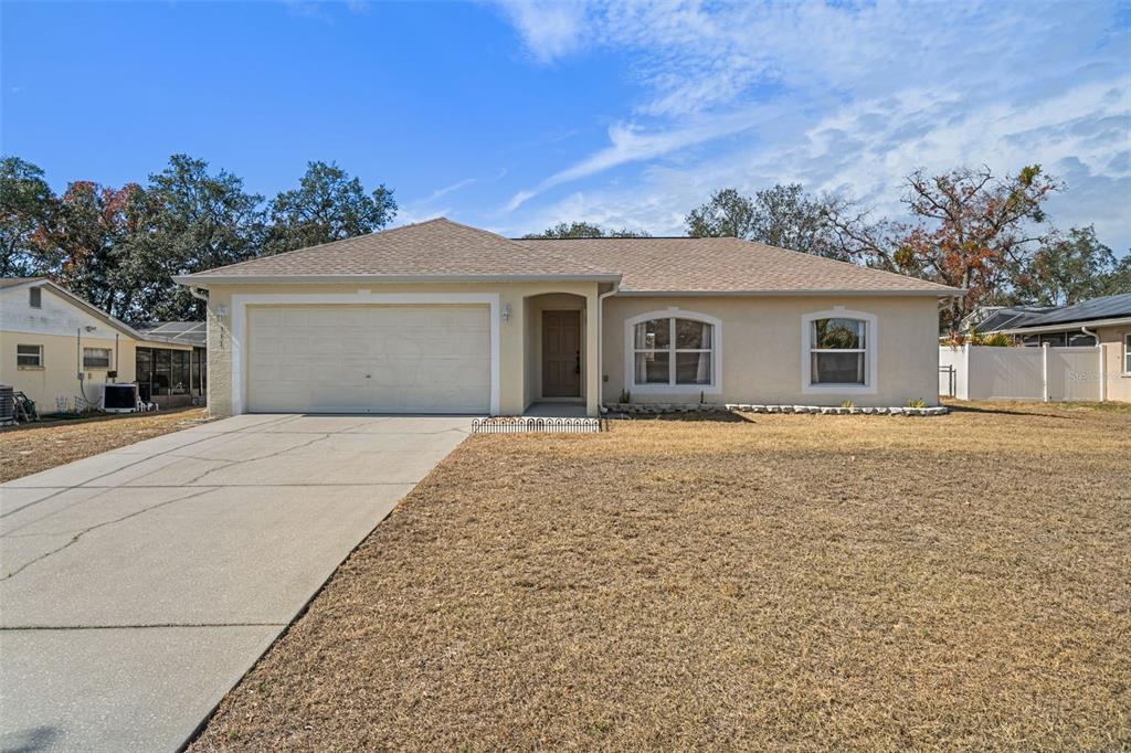 351 Upland Avenue Spring Hill, FL 34606 - Photo 1 of 1 front view of a house with a yard