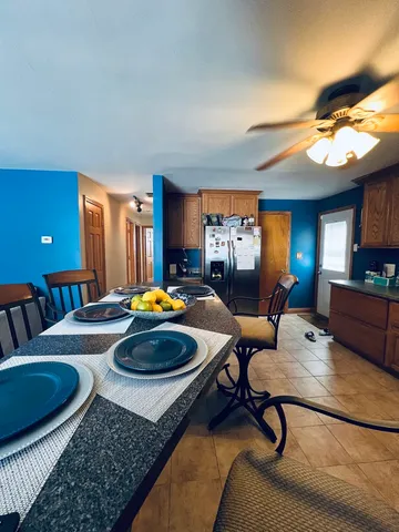 a living room with furniture and a dining table