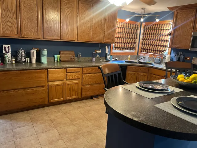a kitchen with stainless steel appliances granite countertop a sink stove and cabinets