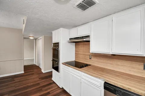 a kitchen with a sink and cabinets