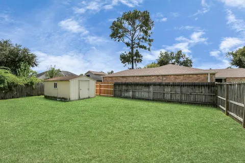 an aerial view of a house with a yard basket ball court and outdoor seating
